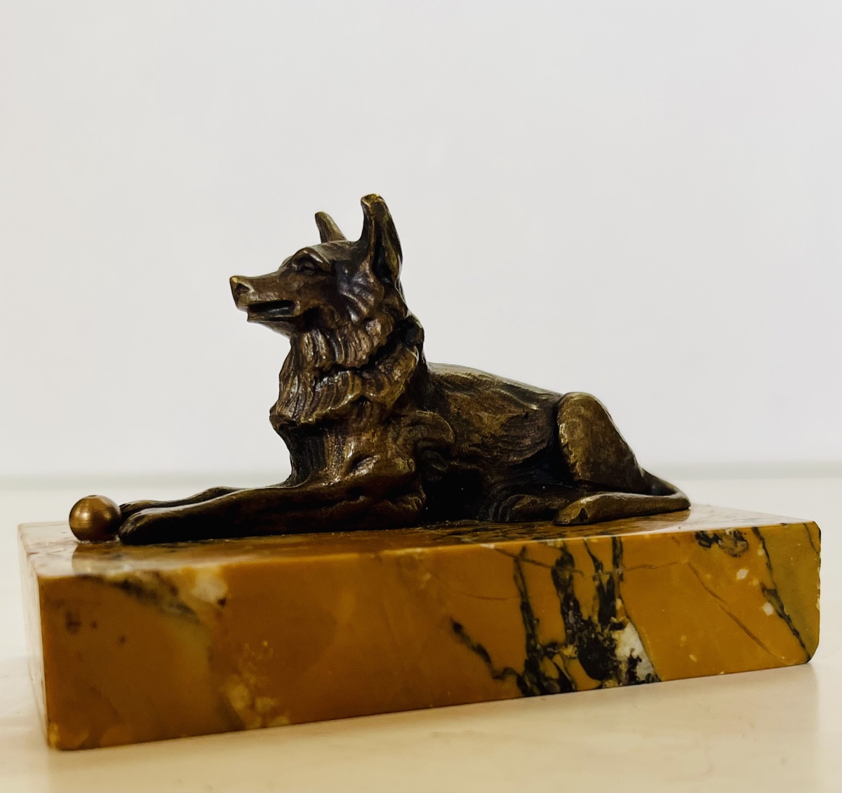 Bronze Dog With A Ball.